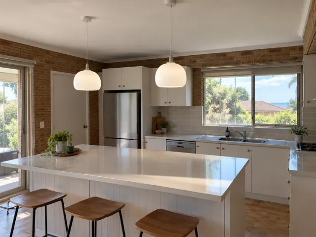 Two white pendant lights above a kitchen island in a modern brick home in Mona Vale